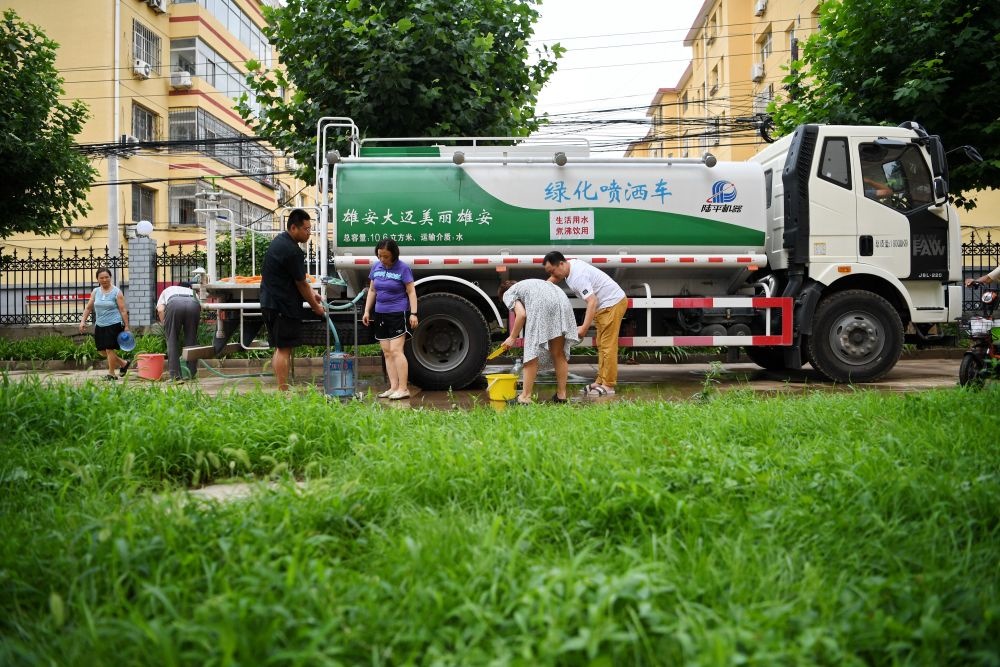河北省涿州市新星小區(qū)居民從供水車?yán)锝铀?月4日攝）。新華社記者 牟宇 攝
