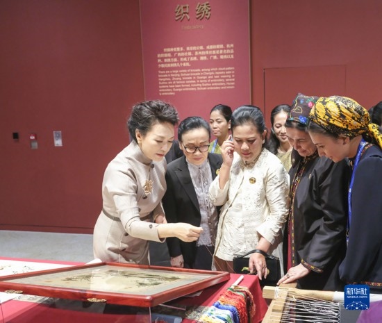  10月18日上午，國家主席習(xí)近平夫人彭麗媛邀請出席第三屆“一帶一路”國際合作高峰論壇的外方領(lǐng)導(dǎo)人夫人參觀中國工藝美術(shù)館（中國非物質(zhì)文化遺產(chǎn)館）。這是彭麗媛同外方領(lǐng)導(dǎo)人夫人觀看刺繡。新華社記者 殷博古 攝