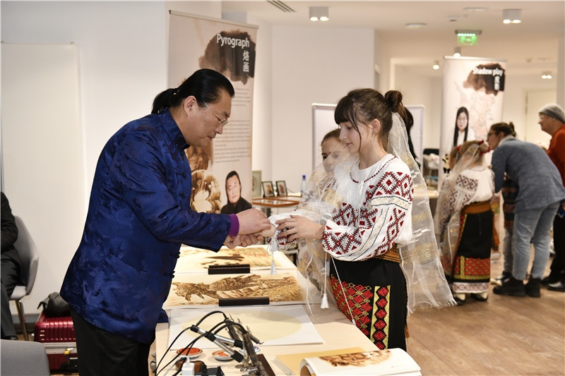 圖為羅馬尼亞小學(xué)生在現(xiàn)場體驗烙畫。 布加勒斯特中國文化中心供圖