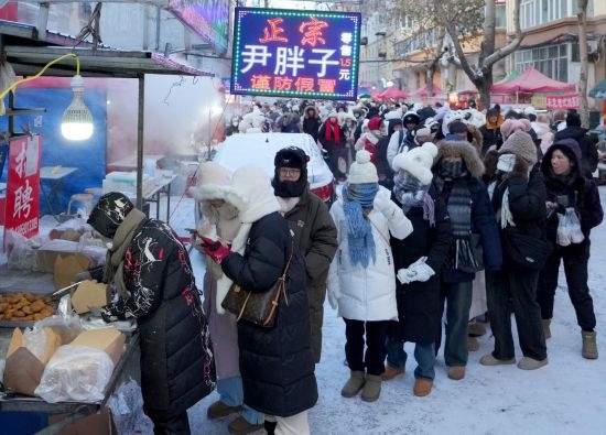 在哈爾濱紅專街早市，顧客們排起長隊購買油炸糕（1月22日攝）。新華社記者 王毓國 攝