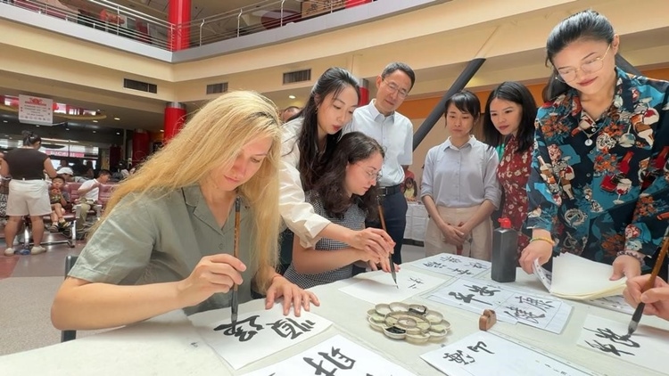 羅馬尼亞友人在活動現(xiàn)場學寫漢字。中國駐羅馬尼亞大使館領僑處供圖