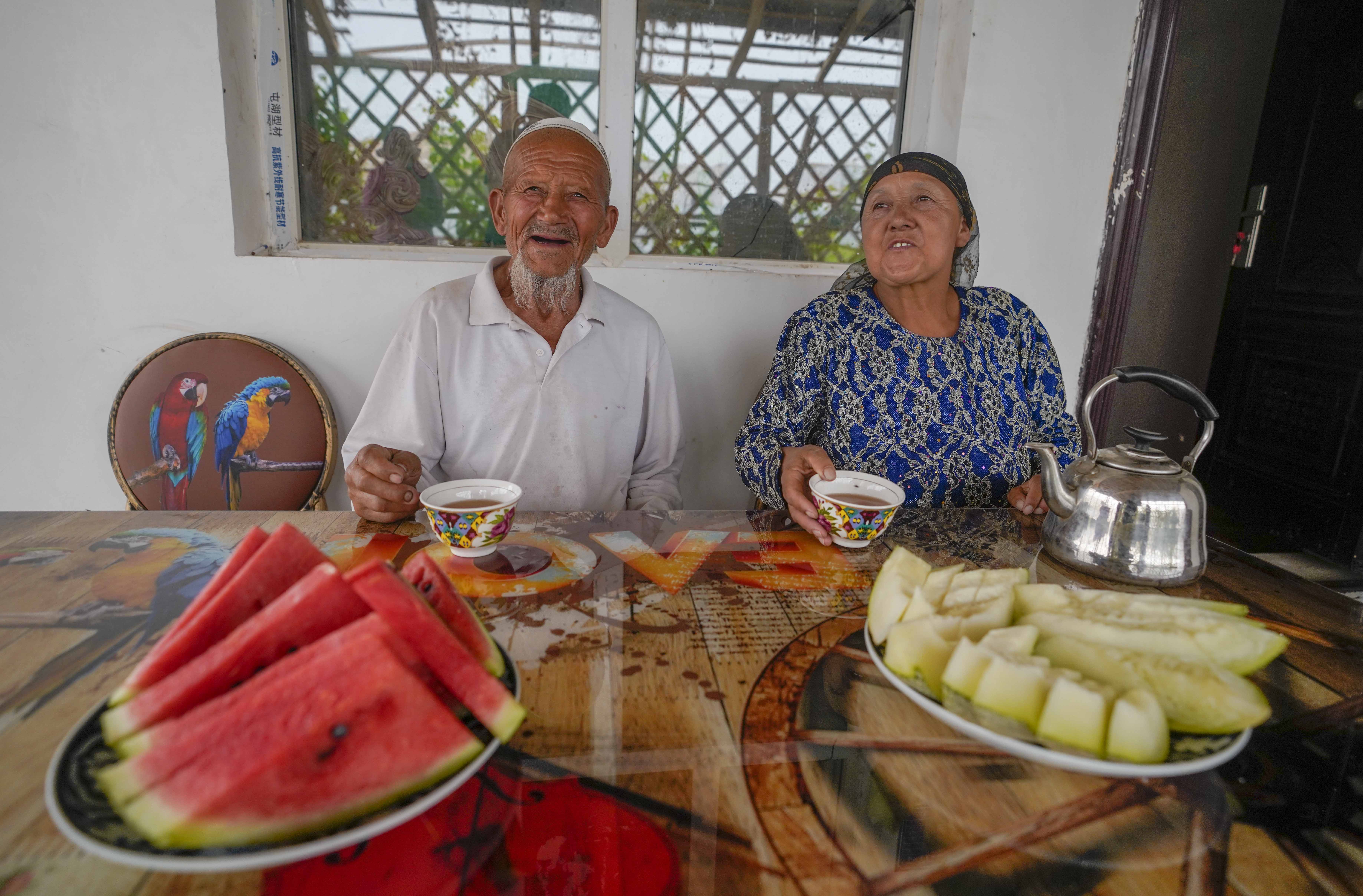 在新疆喀什地區(qū)伽師縣江巴孜鄉(xiāng)依帕克其村57號，80歲的維吾爾族老人伊米提·艾山（左）在自家庭院中（2020年6月8日攝）。